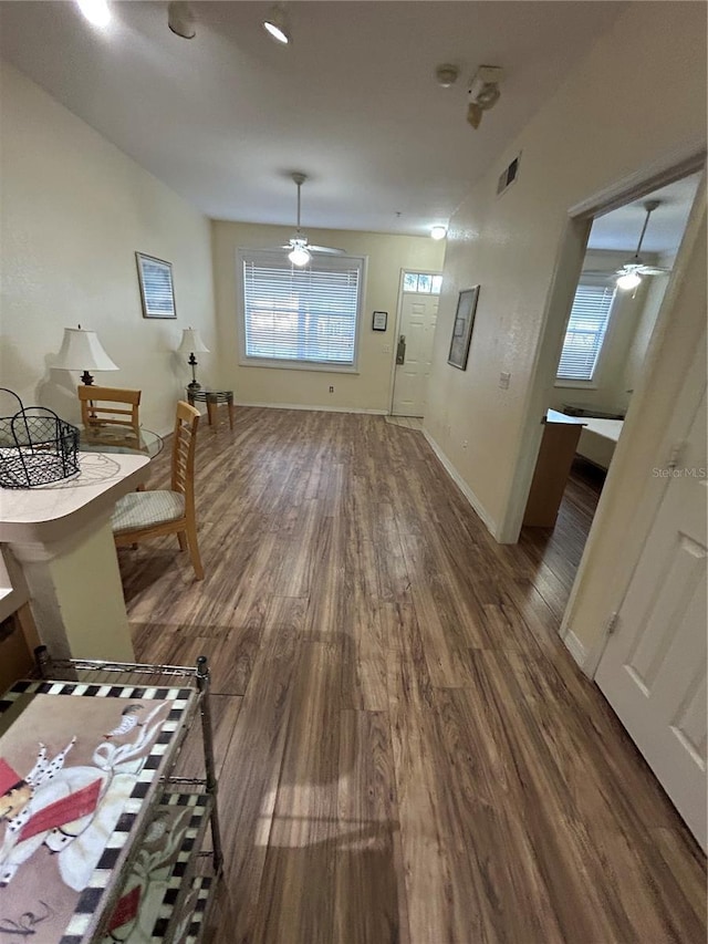 dining room with dark hardwood / wood-style flooring and ceiling fan