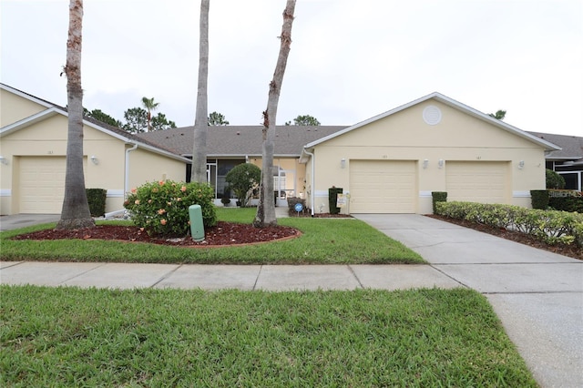 ranch-style home featuring a front lawn, a garage, driveway, and stucco siding