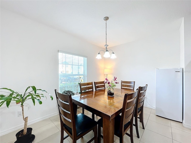 tiled dining space with a notable chandelier