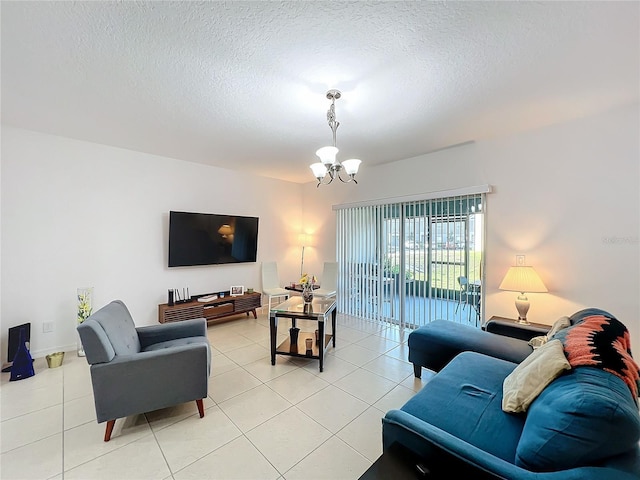 living room with an inviting chandelier, a textured ceiling, and light tile patterned flooring