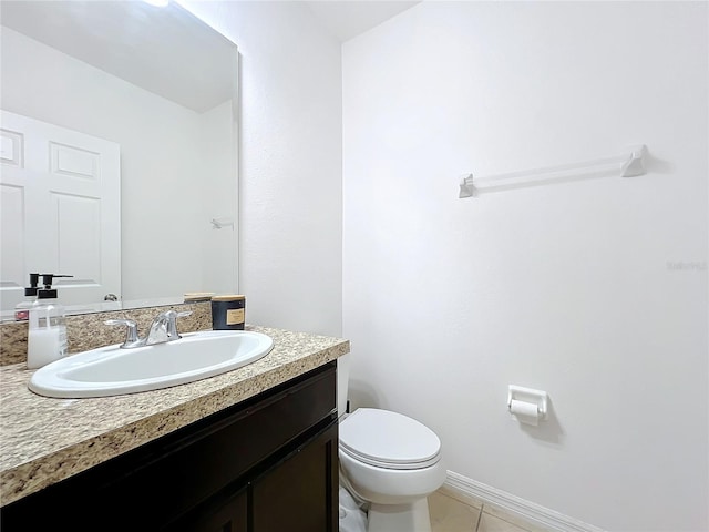 bathroom with vanity, toilet, and tile patterned flooring