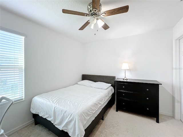 bedroom with light carpet and ceiling fan