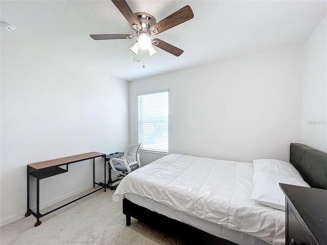 bedroom featuring ceiling fan and light carpet