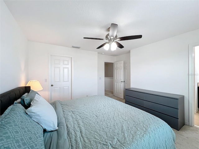 bedroom with ceiling fan and light carpet