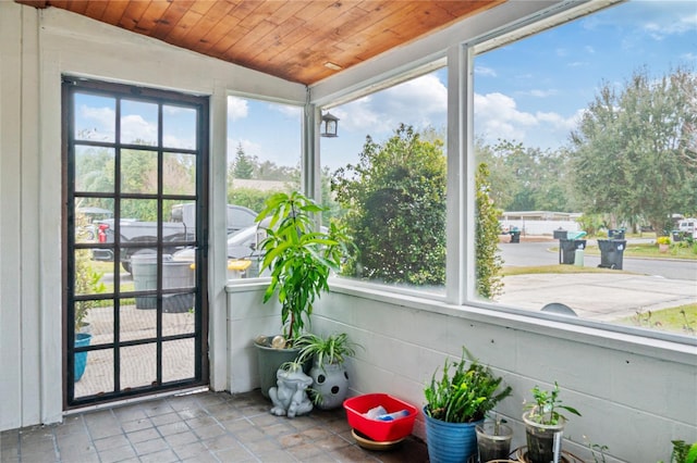 sunroom / solarium featuring a wealth of natural light and wooden ceiling