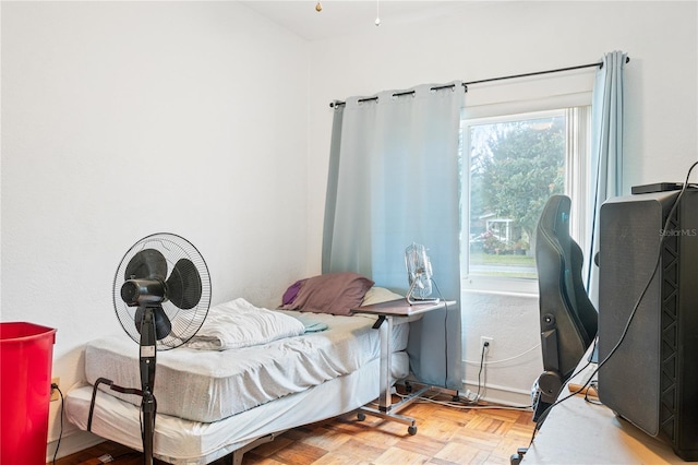 bedroom with light parquet flooring