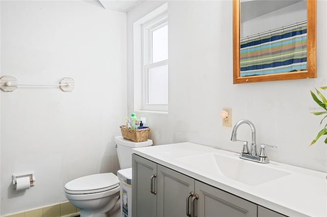 bathroom with vanity, toilet, and walk in shower