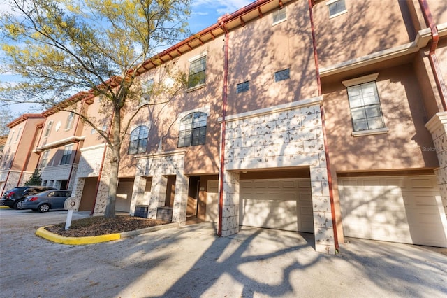 townhome / multi-family property featuring a garage