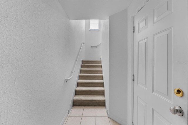 staircase with tile patterned floors