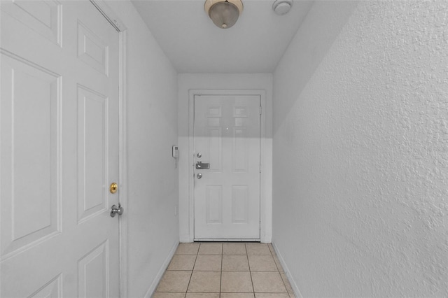 doorway with light tile patterned flooring