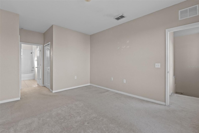 unfurnished room with light colored carpet