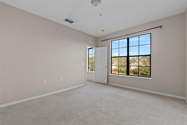 empty room featuring light colored carpet