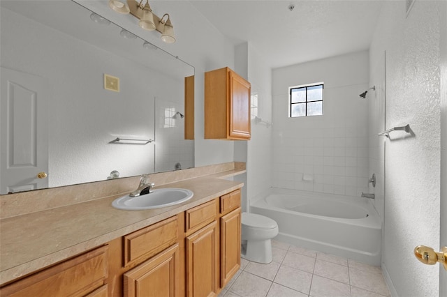 full bathroom featuring vanity, tiled shower / bath, tile patterned floors, and toilet