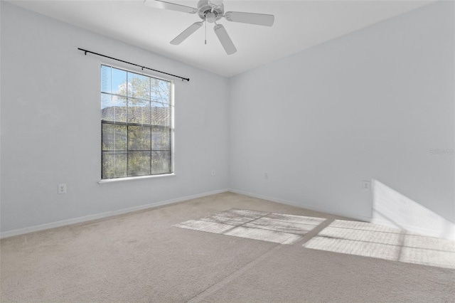 spare room featuring light carpet and ceiling fan