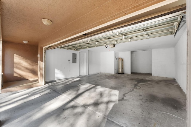 garage with a garage door opener and electric panel