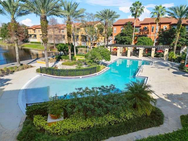 view of pool featuring a water view and a pergola