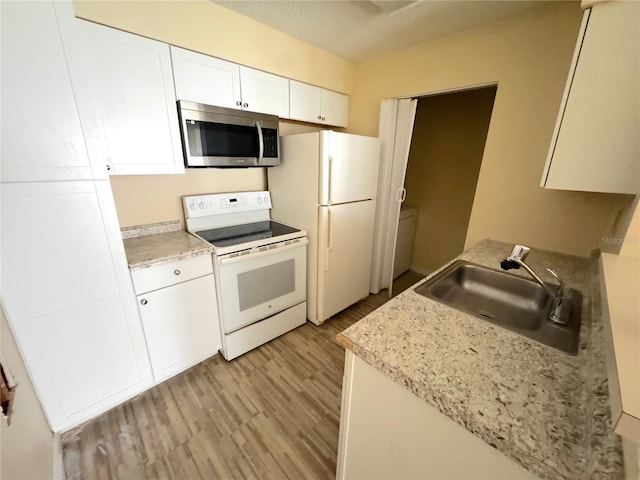 1091 S Hiawassee Rd Unit 216, Orlando, FL 32835 - kitchen with white appliances, a sink, white cabinetry, and light wood-style floors