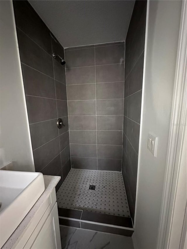 bathroom featuring a stall shower and vanity