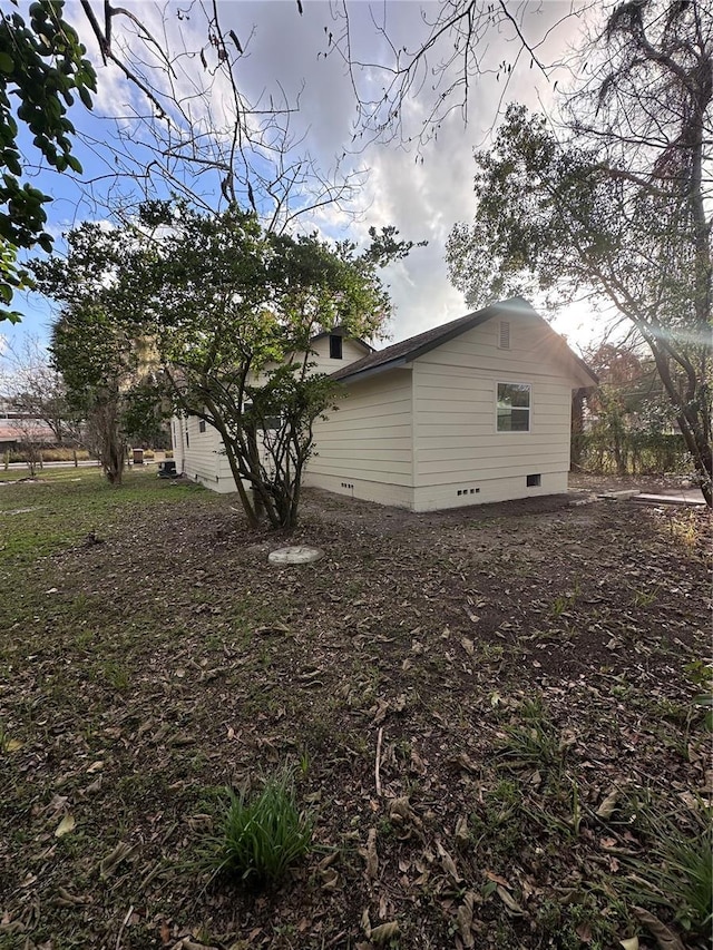 view of side of property with crawl space