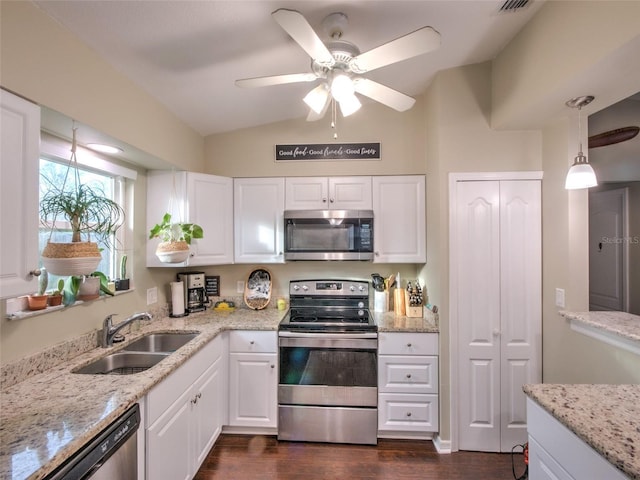 kitchen featuring hanging light fixtures, white cabinetry, appliances with stainless steel finishes, and sink