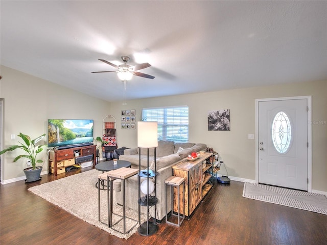 living room with lofted ceiling, dark wood-type flooring, and ceiling fan