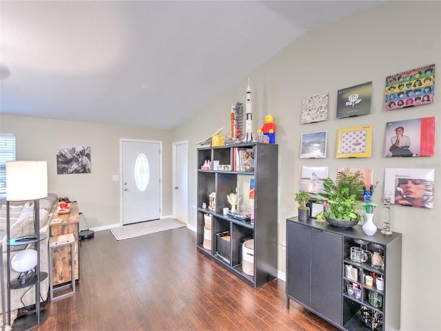 entryway with dark wood-type flooring and lofted ceiling