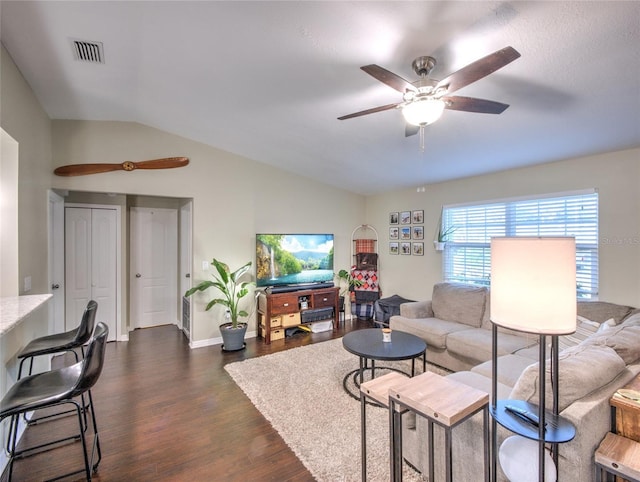 living room featuring vaulted ceiling, dark hardwood / wood-style floors, and ceiling fan