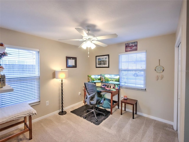 carpeted home office with ceiling fan