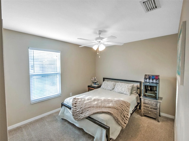 bedroom featuring light carpet and ceiling fan