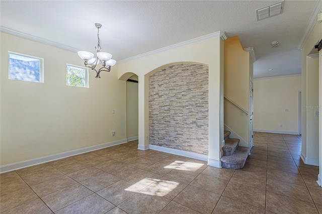 tiled empty room featuring crown molding, a chandelier, and a textured ceiling