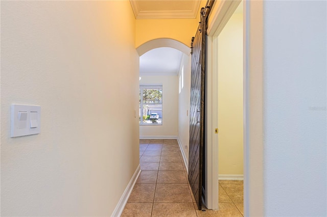 hall featuring light tile patterned floors and ornamental molding