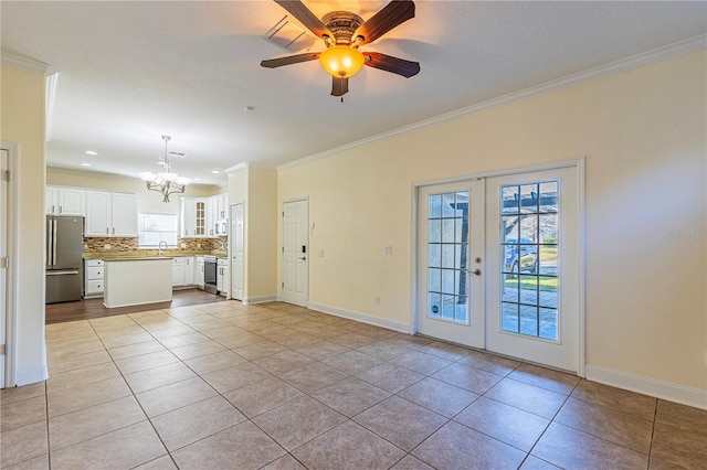 unfurnished living room with crown molding, french doors, and light tile patterned flooring