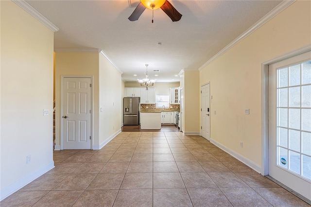 interior space featuring crown molding, a healthy amount of sunlight, ceiling fan with notable chandelier, and light tile patterned floors