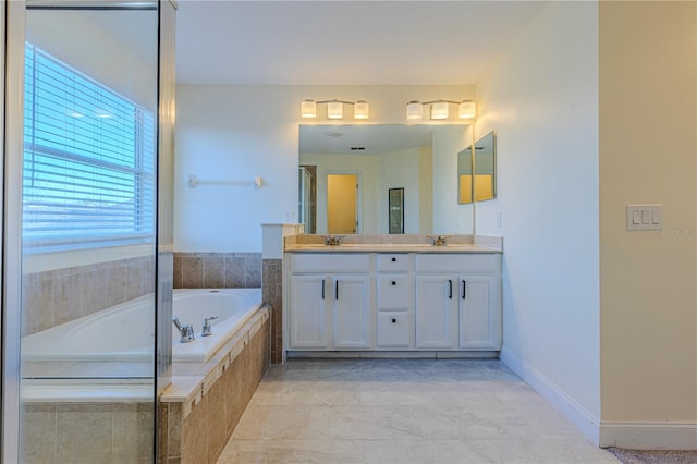 bathroom with vanity and tiled bath