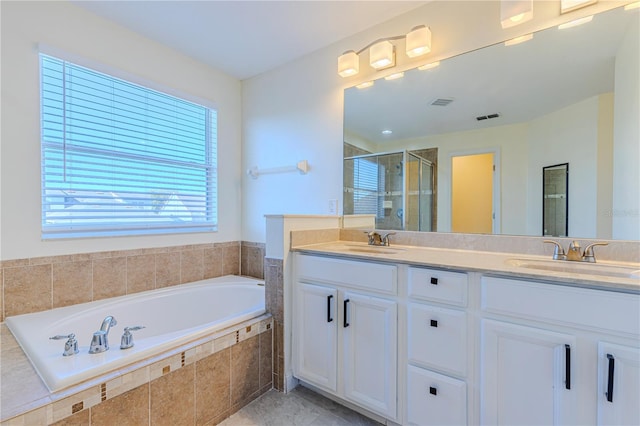 bathroom with vanity and independent shower and bath