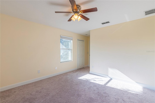 carpeted empty room with ceiling fan