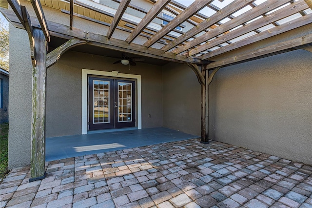 view of patio / terrace featuring french doors, ceiling fan, and a pergola