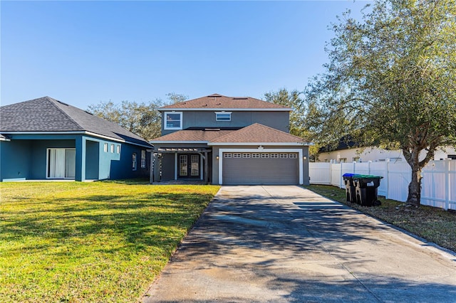 view of front of property featuring a garage and a front lawn