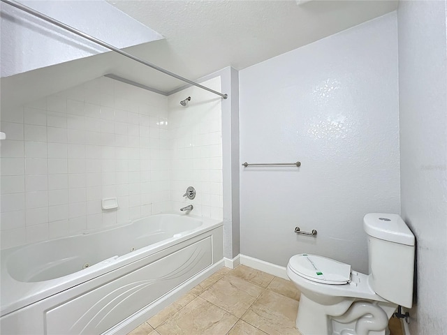 bathroom with tiled shower / bath, a textured ceiling, and toilet