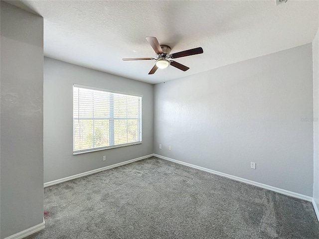 unfurnished room with ceiling fan, carpet floors, and a textured ceiling