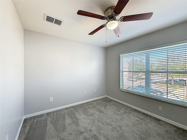 carpeted spare room featuring ceiling fan