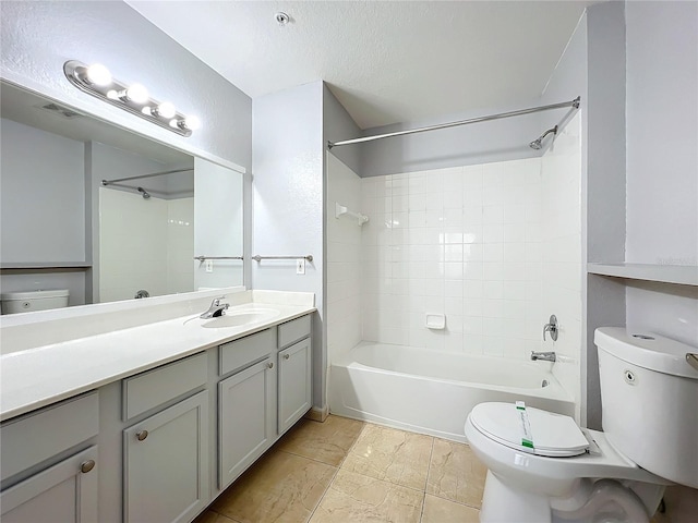 full bathroom featuring tiled shower / bath combo, vanity, a textured ceiling, and toilet