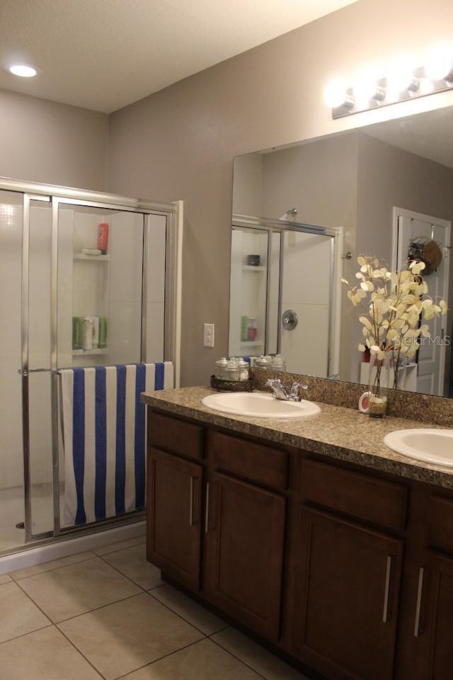 bathroom featuring an enclosed shower, vanity, and tile patterned floors