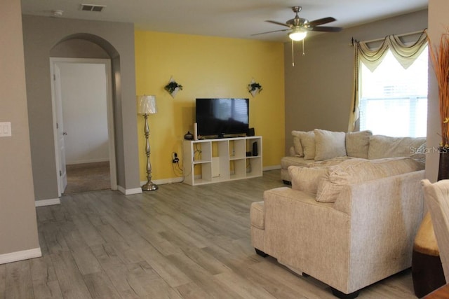 living room featuring hardwood / wood-style flooring and ceiling fan