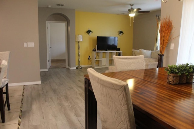 living room featuring ceiling fan and light wood-type flooring