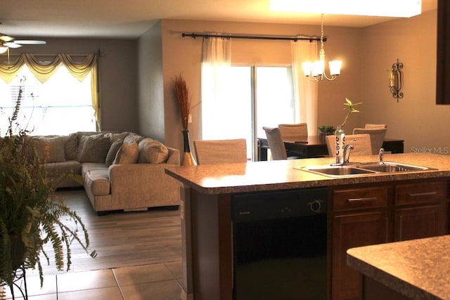 kitchen with ceiling fan with notable chandelier, black dishwasher, sink, hanging light fixtures, and tile patterned flooring