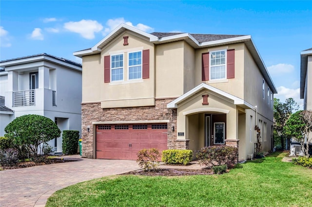 view of front of home featuring a garage and a front yard