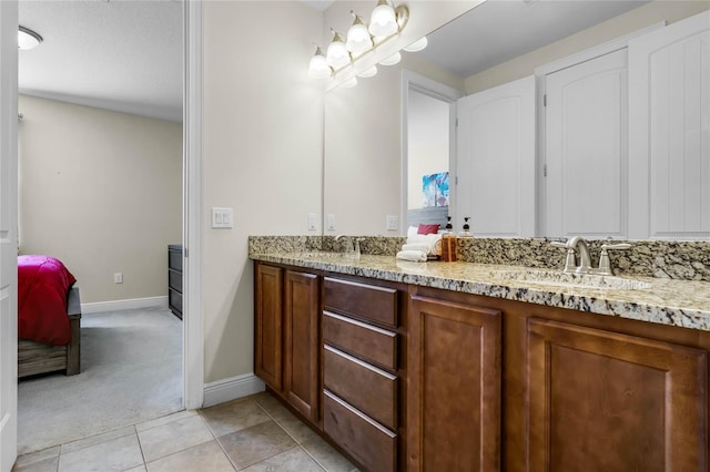 bathroom with tile patterned flooring and vanity