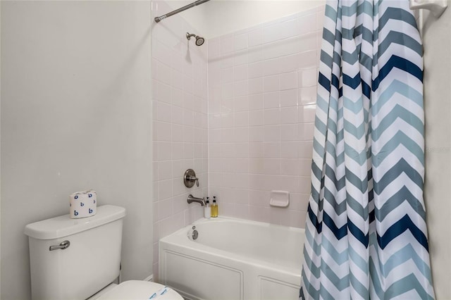 bathroom featuring shower / bath combination with curtain and toilet