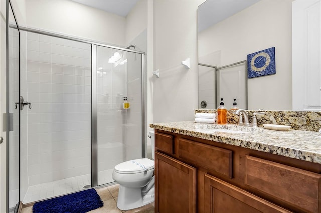 bathroom with vanity, an enclosed shower, tile patterned flooring, and toilet